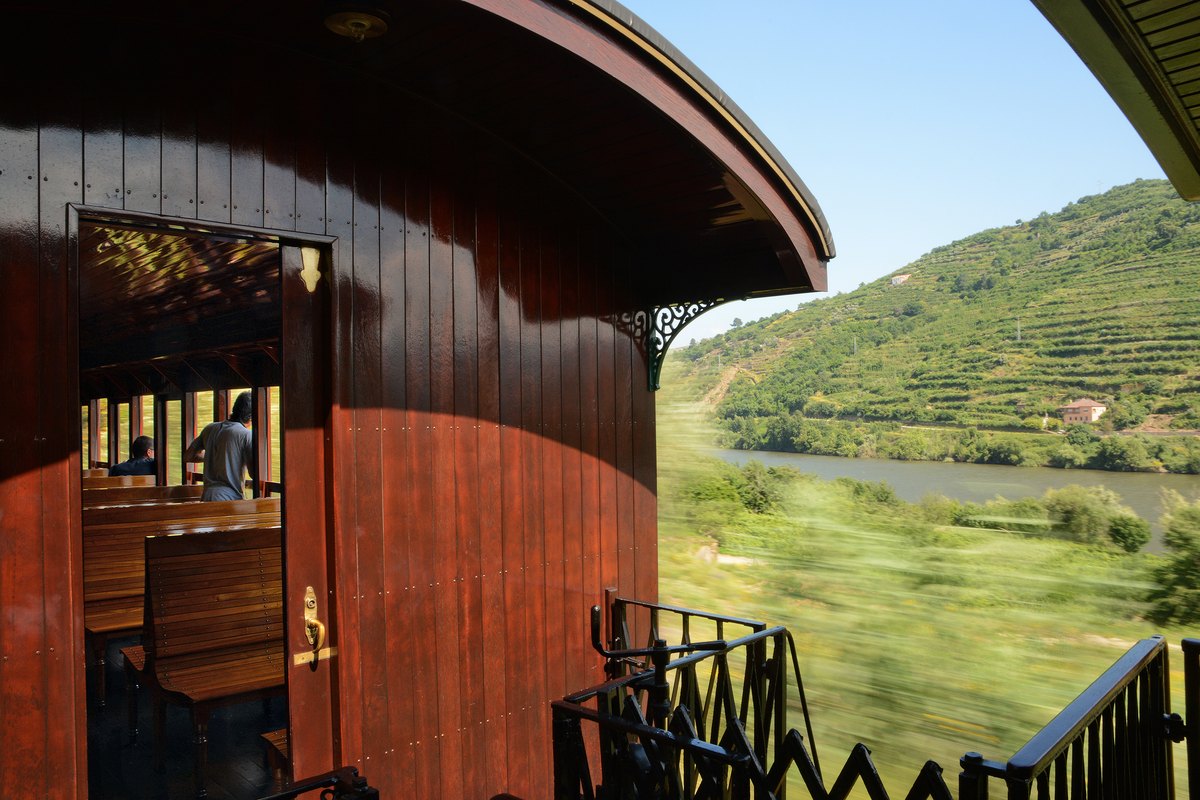 A vintage train carriage on the Douro line above the terraced river valley, Portugal
